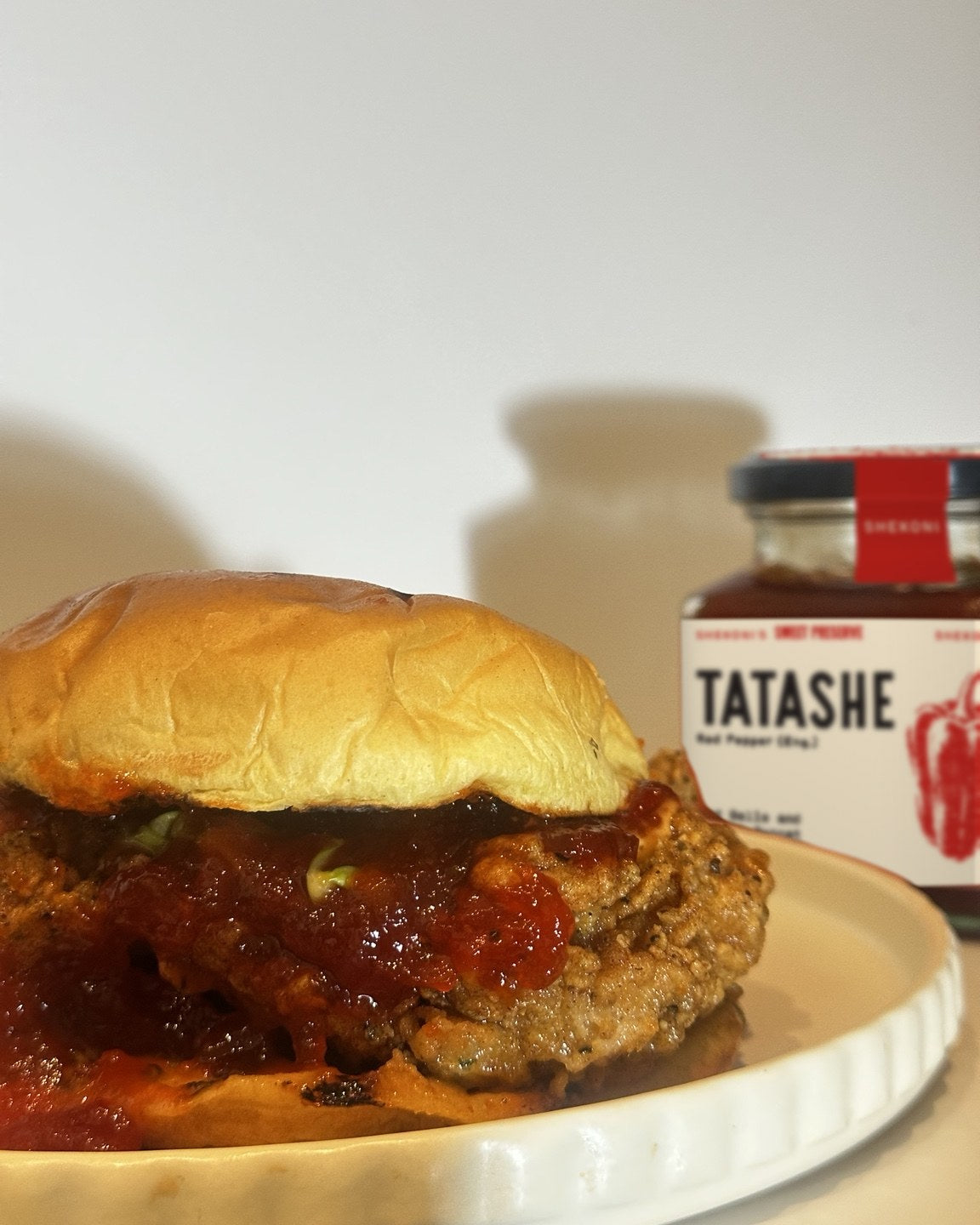 Crispy chicken burger with Tatashe and a jar of Tatashe