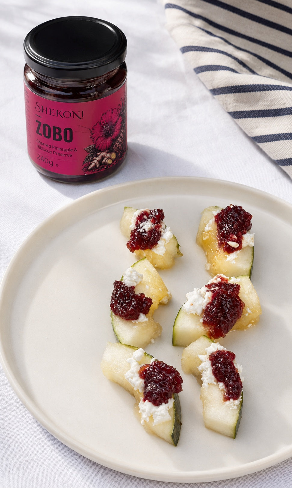 Zobo charred pineapple and hibiscus preserve on melon with soft goat cheese